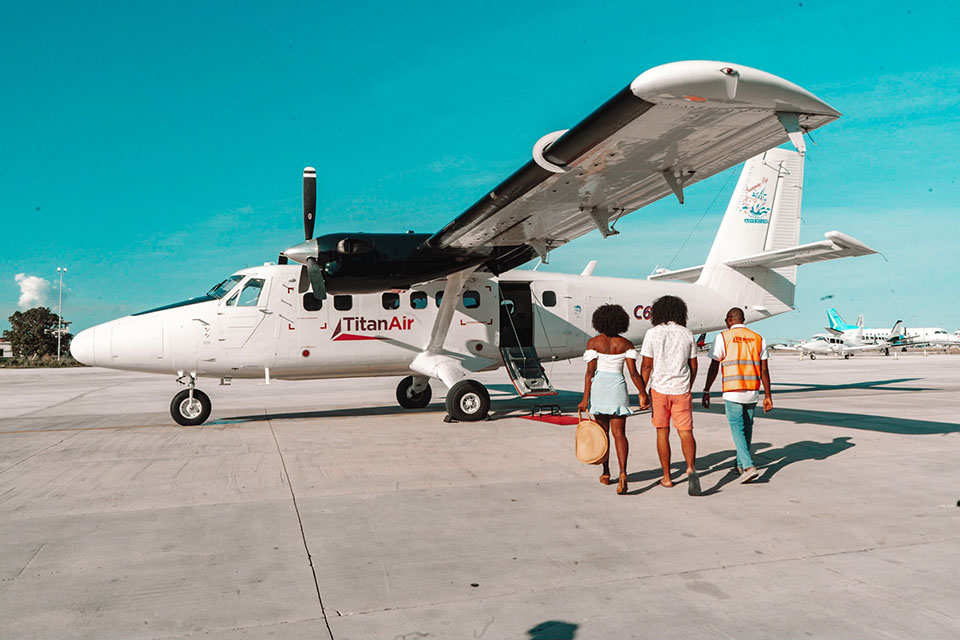 Passenger walking toward Titan Air aircraft